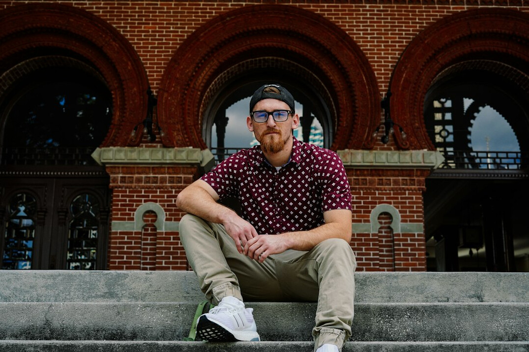 Portrait of a bearded man in his thirties wearing glasses