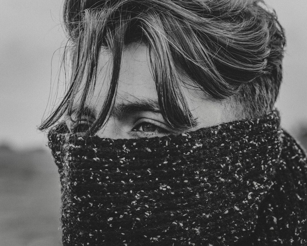 Portrait of a young man screenwriter with wavy hair and a scarf