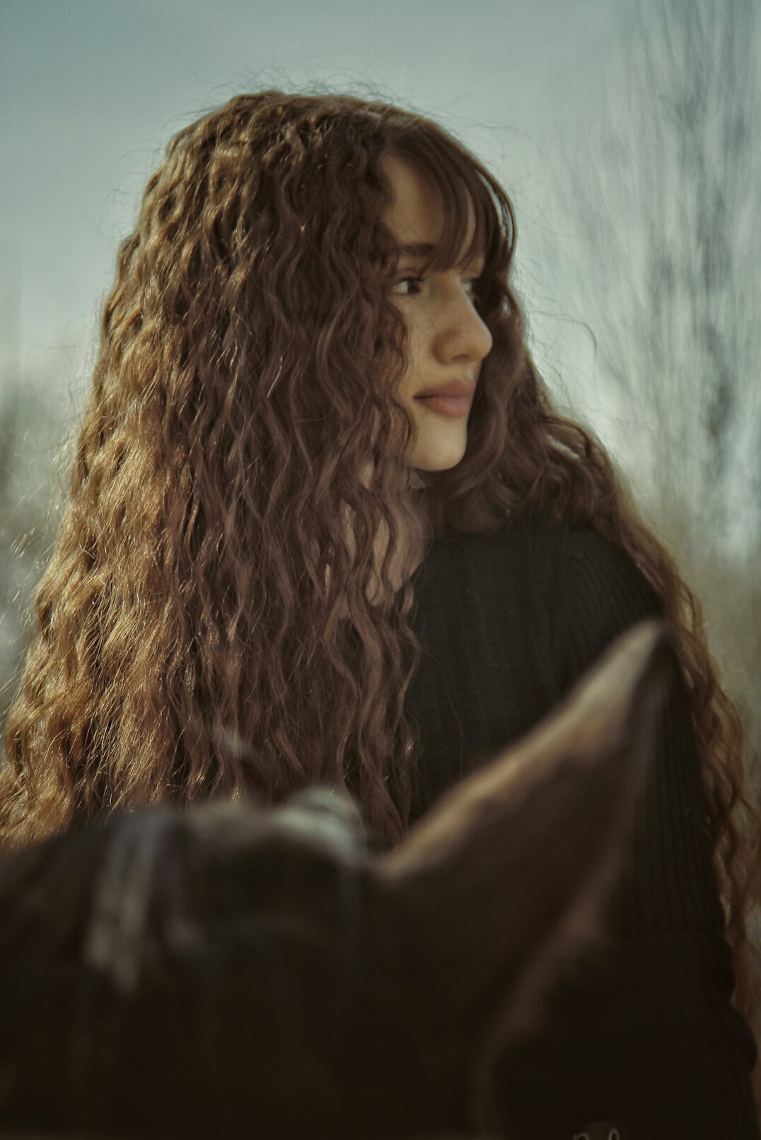 Portrait of a woman linguist with long wavy brown hair